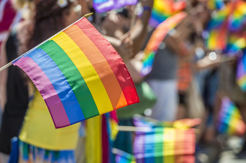 Close-up of multi colored flags against blurred background