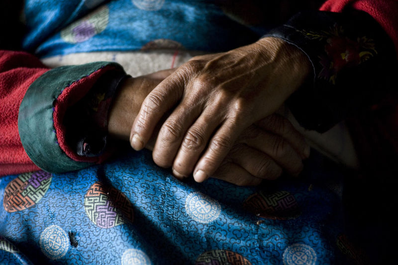 A close-up of the hands of a traditionally attired nepali woman, 26th may 2009, nepal.