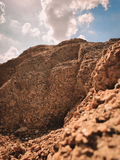 Low angle view of rock formation on land against sky