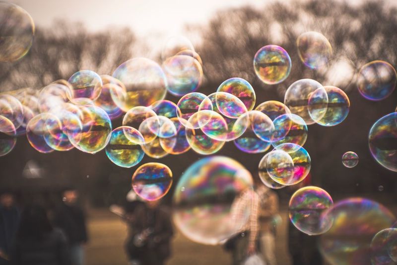 Multi colored bubbles against blurred background