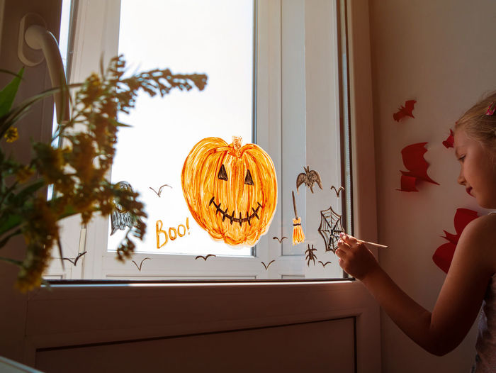 Woman holding pumpkin at home