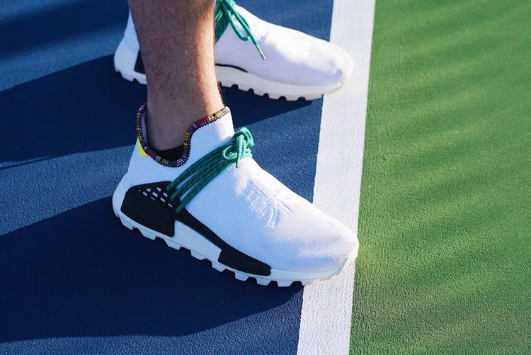 Cool sneakers on blue and green tennis court