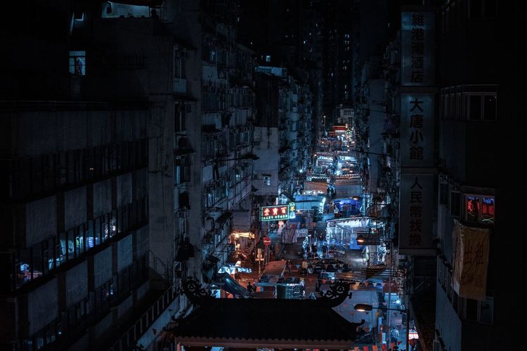 High angle view of illuminated cyberpunk  buildings in city at night 