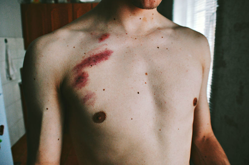 Midsection of shirtless man
