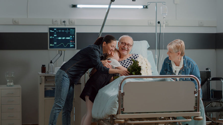 Family members embracing patient in hospital