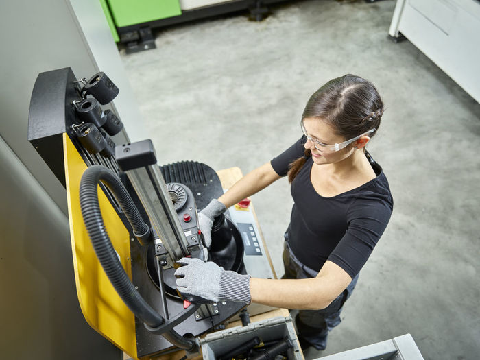 Young woman working on a machine