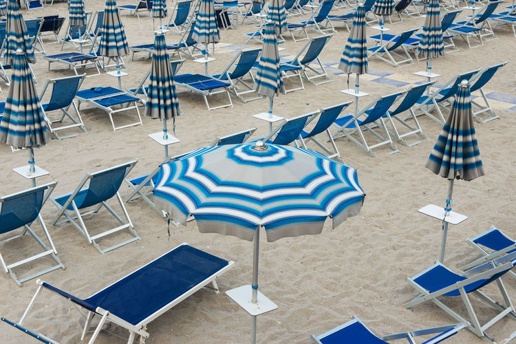 Canopies and sun loungers on shore