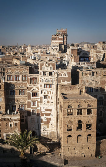 High angle view of old buildings against clear sky in city