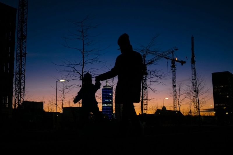 Silhouette of father and son holding hands