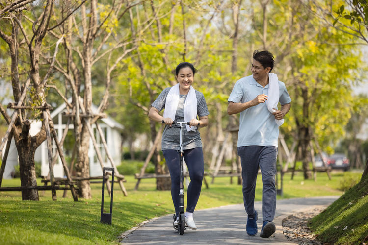 Happy asia senior couple jogging outdoors in park. person