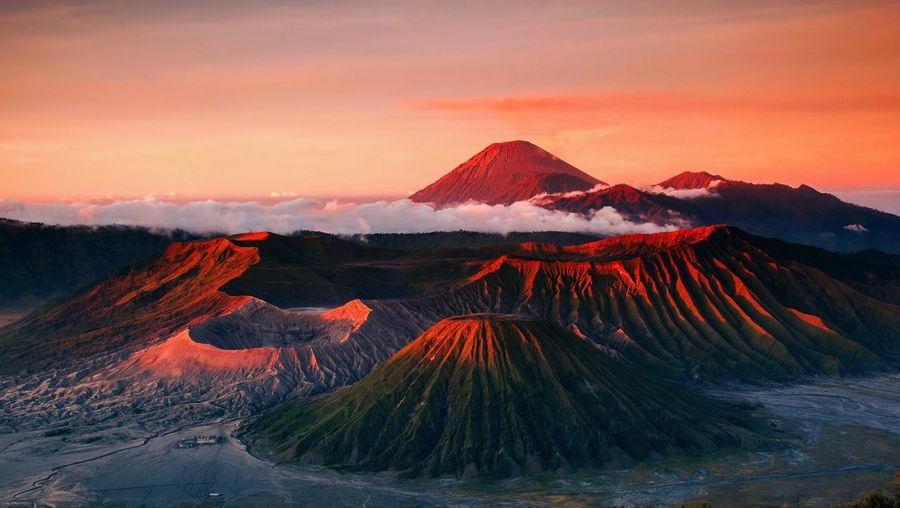Panoramic view of volcanic mountain against sky during sunset