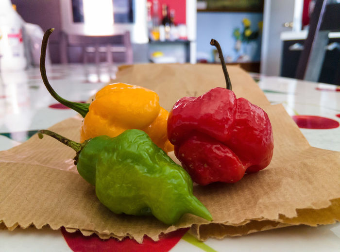 Close-up of bell peppers kept on paper bag at home