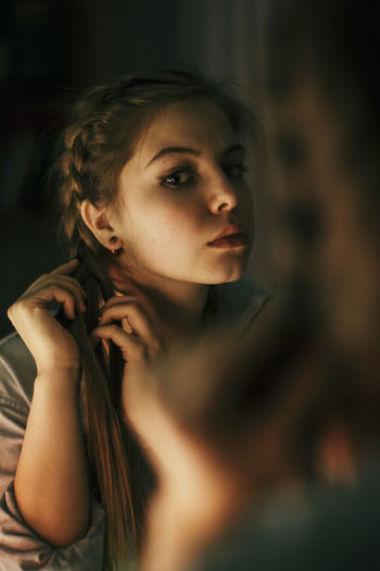 Portrait of young woman in mirror