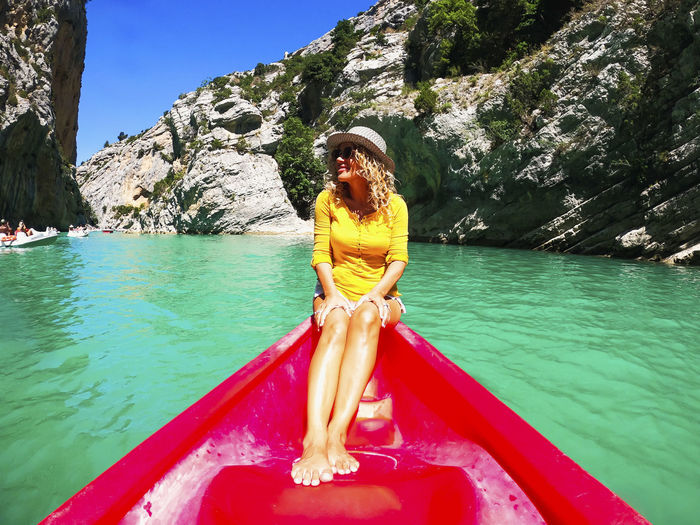 Side view of woman in boat in lake