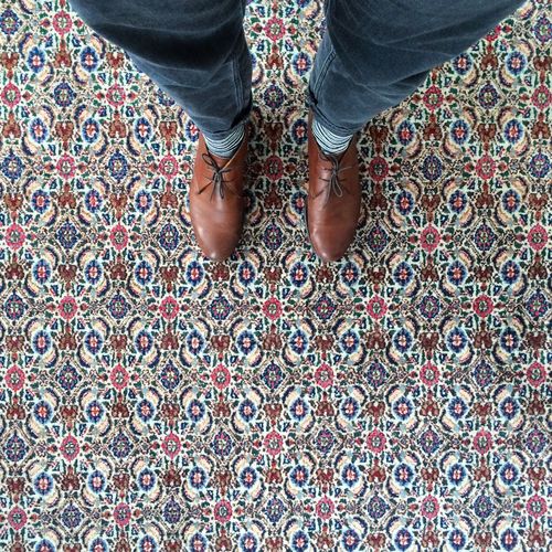 Low section of person standing on carpet