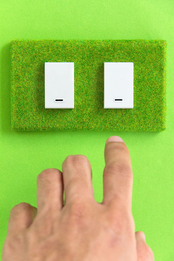 Cropped hand of man touching switch