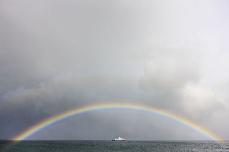 Rainbow over sea against sky
