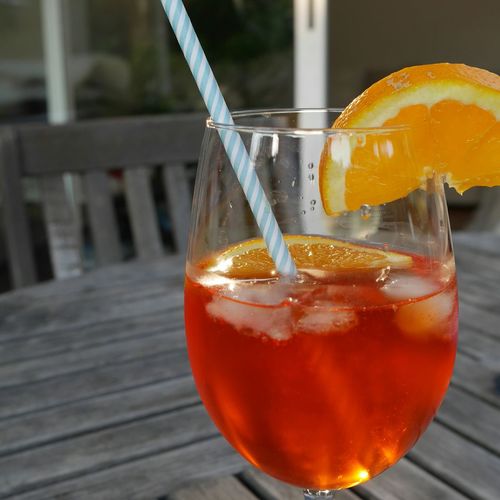 Close-up of aperol spritz in wineglass on table