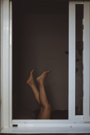 Low section of woman in room