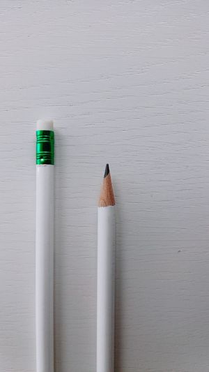 Close-up of pencils over white background