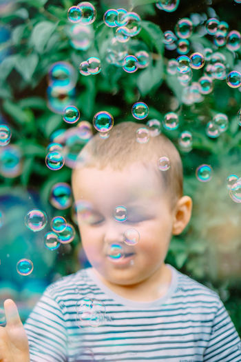 Portrait of cute boy blowing bubbles