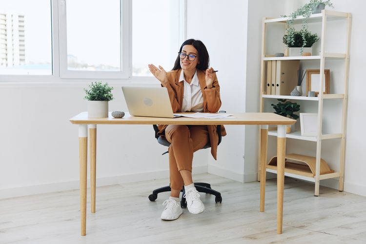 Side view of woman using mobile phone while sitting at home