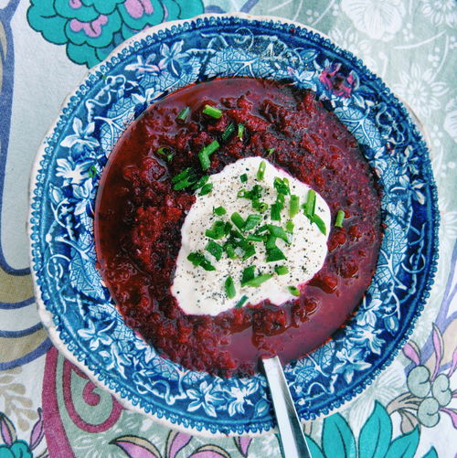 Directly above view of beet soup with sour cream in bowl