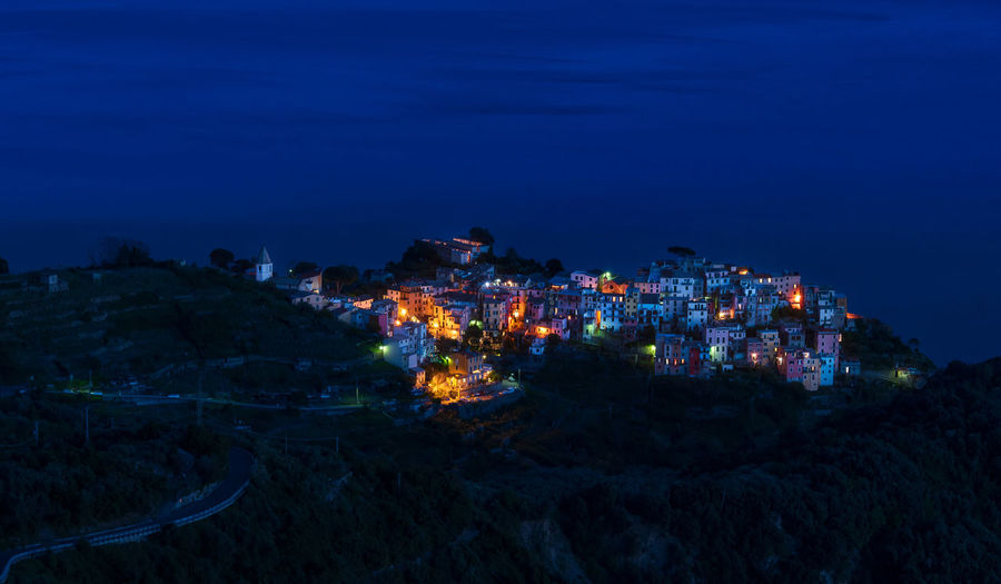 The village of corniglia in cinque terre, italy, illuminated at night turns it into a fairy tale