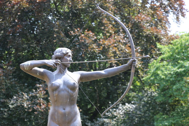 Statue against trees