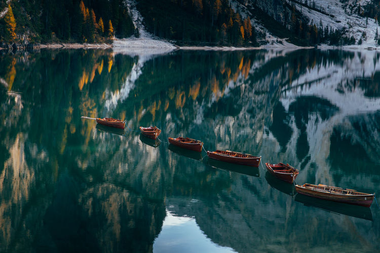 Boats in lake against mountains