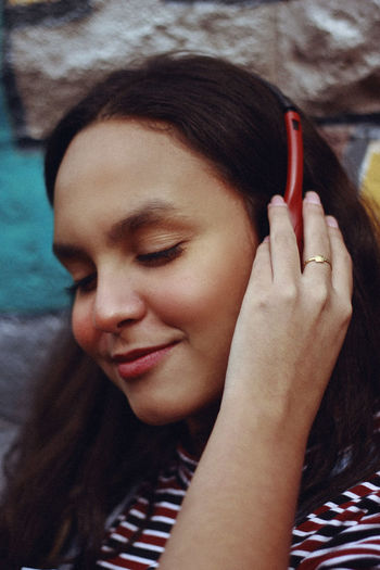 Close-up of woman listening music