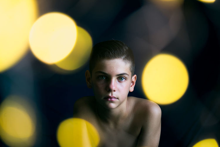 Portrait of boy with yellow balloons