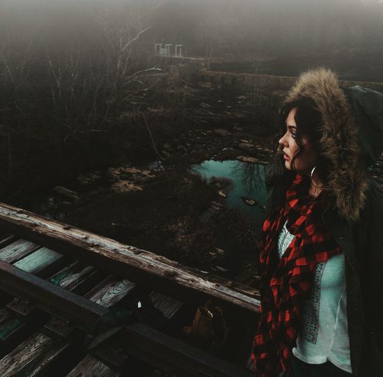 Woman standing on railway tracks