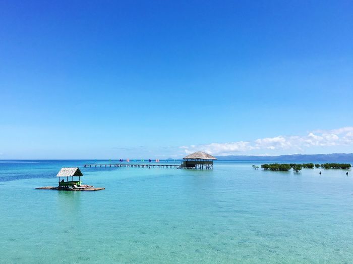 Scenic view of sea against clear blue sky