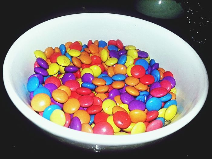 Close-up of multi colored candies in bowl