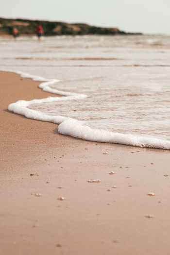 Close-up of cigarette on sand at beach