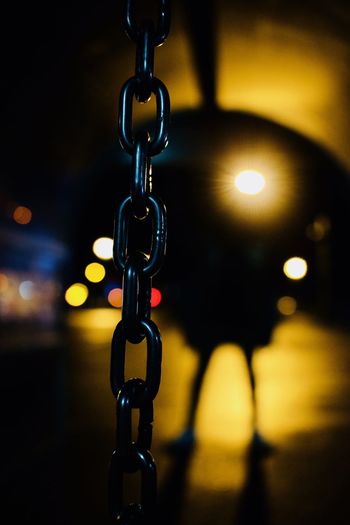 Close-up of chain hanging at night