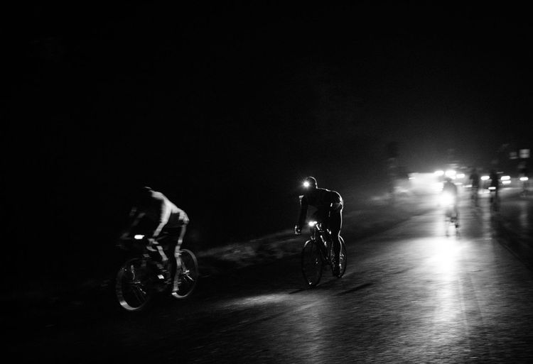 Man riding bicycle at night