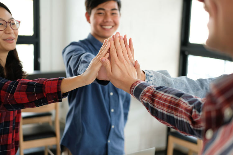 Business people giving high five in office