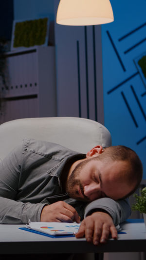 Man sleeping on table at home