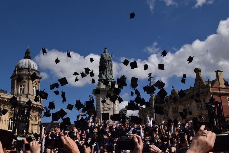 People throwing graduation caps