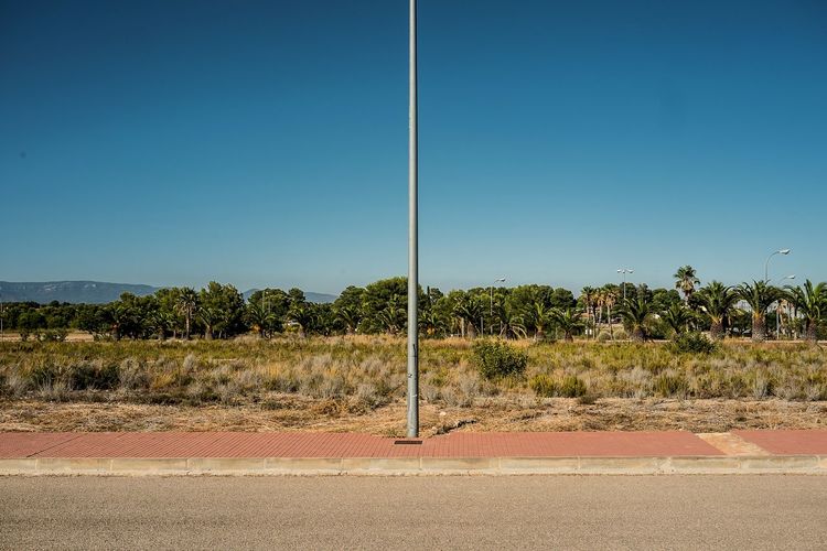 Scenic view of landscape against clear blue sky