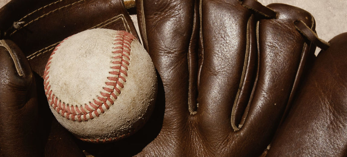 Close-up of baseball on gloves