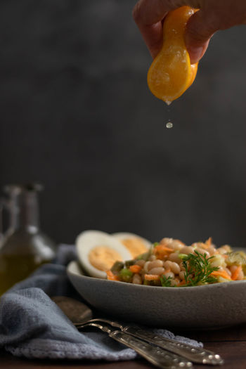Squeeze lemon over cooked bean salad