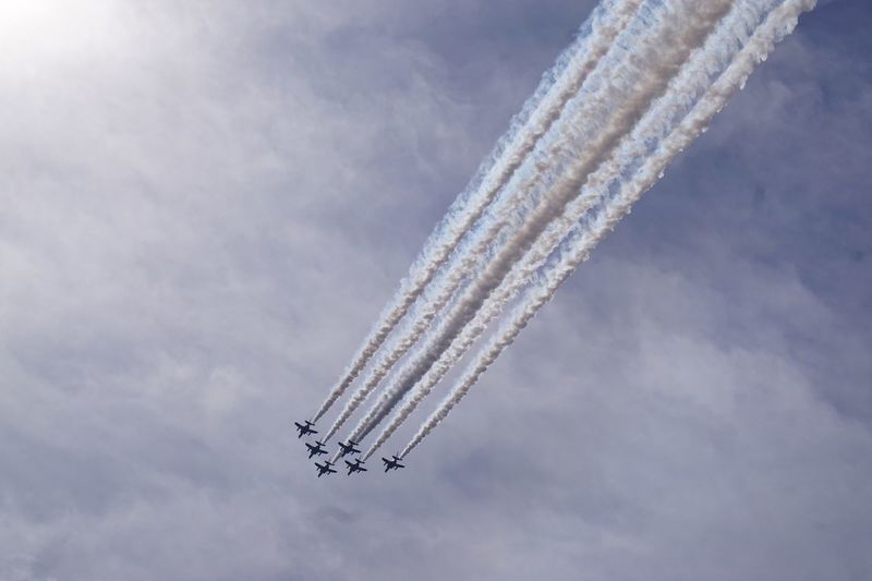Low angle view of airshow against sky