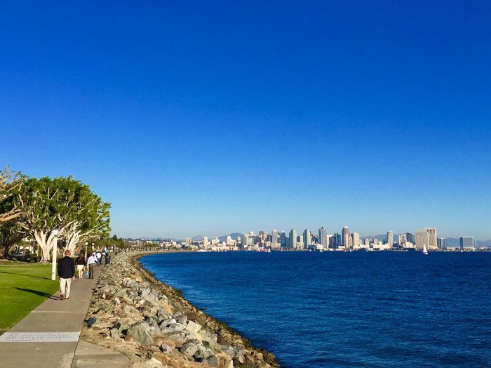 View of cityscape against clear blue sky