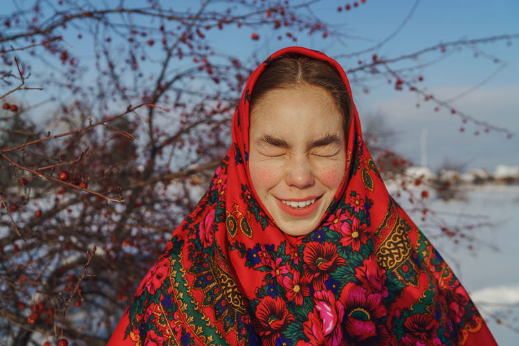 Portrait of a smiling young woman in a red shawl