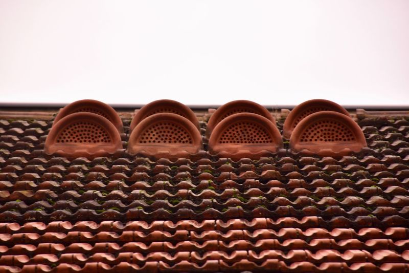 Close-up of roof tiles against clear sky