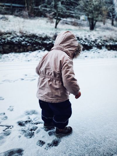 Side view of child wearing jacket on field during winter
