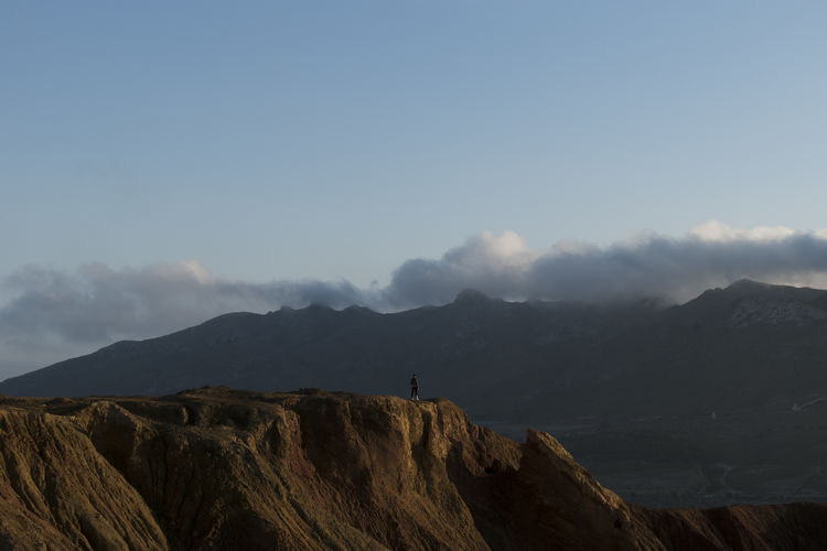 Woman on old abandoned mine view the mountains with clouds background in murcia, spain